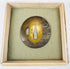 Late Edo Japanese mixed-metal tsuba with mounted warrior and horse relief displayed on green textile cushion