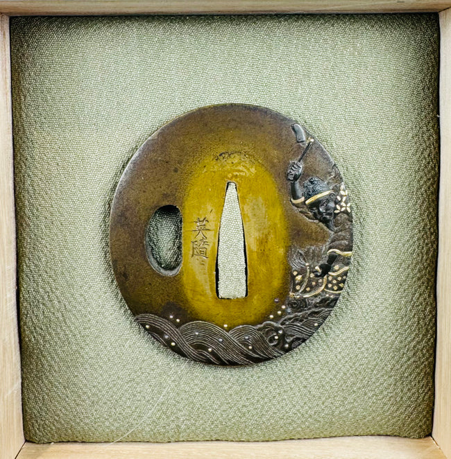 Signed Eizui Japanese sword guard displayed in fitted wooden collector’s box with textile-covered cushion