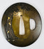 Reverse of circa 1840 Eizui tsuba showing pine tree decoration with gold accents on patinated copper alloy