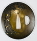 Reverse of circa 1840 Eizui tsuba showing pine tree decoration with gold accents on patinated copper alloy