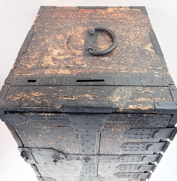 Top view of Japanese ship chest showing large iron carrying handle, deposit slots and heavily worn black finish