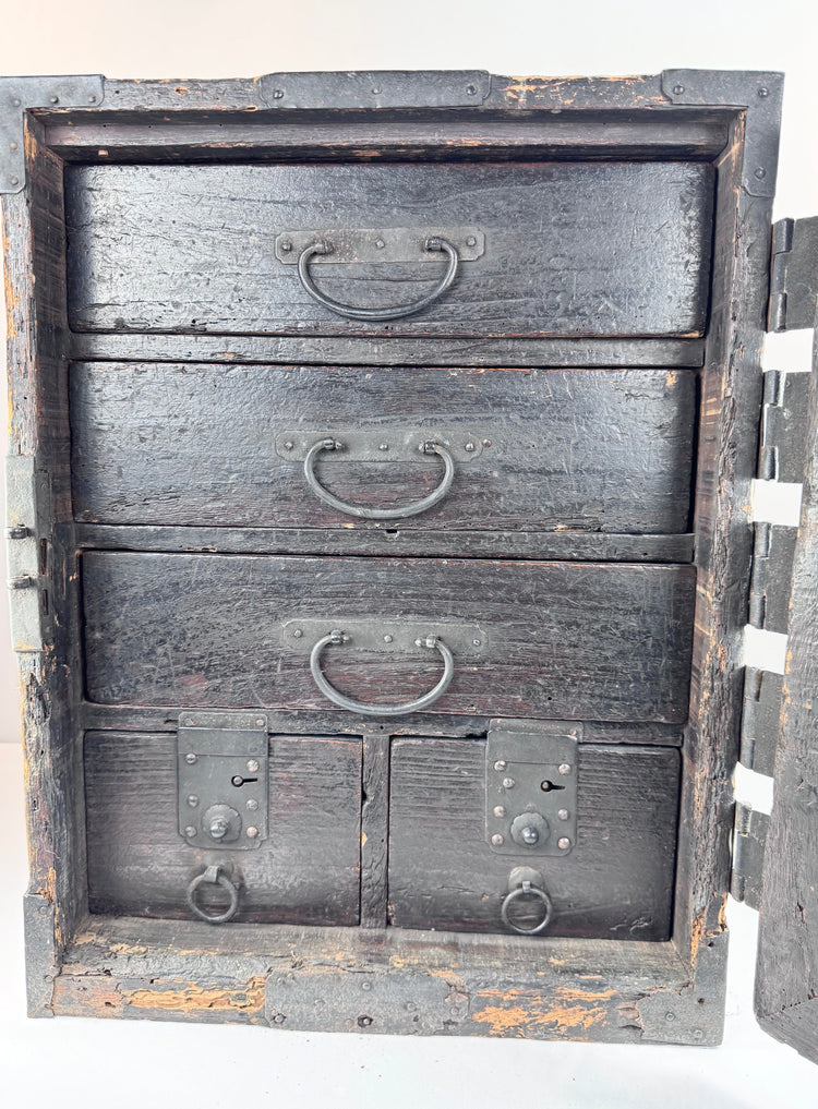 Japanese funa tansu with reinforced front door opened to reveal five interior drawers with traditional iron ring pulls