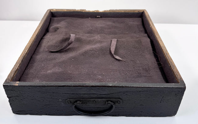 Interior view of Japanese funa tansu drawer showing fitted dark textile lining, fabric straps and later silver-storage conversion