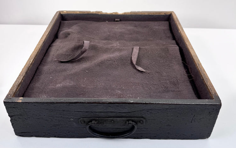 Interior view of Japanese funa tansu drawer showing fitted dark textile lining, fabric straps and later silver-storage conversion
