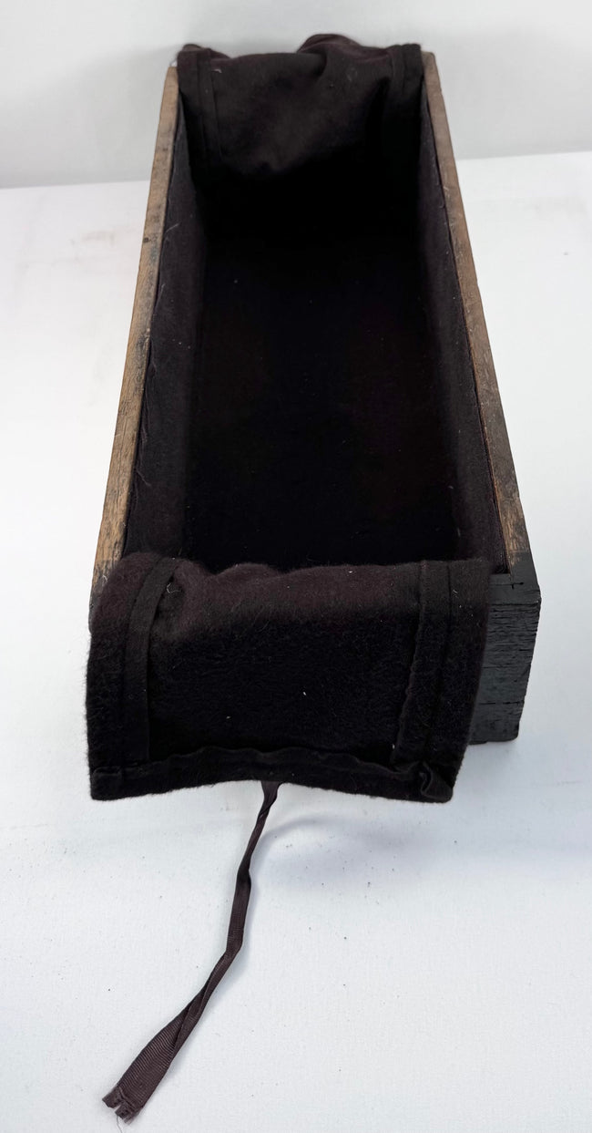 Side view into long narrow drawer from antique Japanese ship chest showing depth, textile lining and aged wood construction