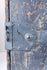 Close-up of Japanese ship chest front showing chrysanthemum-form lock fitting, riveted ironwork and hand-forged hardware