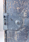 Close-up of Japanese ship chest front showing chrysanthemum-form lock fitting, riveted ironwork and hand-forged hardware