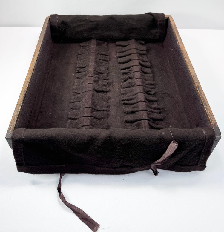 Japanese funa tansu drawer interior with rows of textile loops designed for individual pieces of silver or flatware