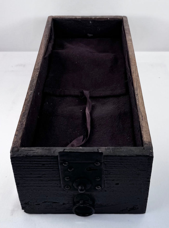 Deep lower drawer from an antique Japanese Edo period funa tansu, showing dark anti-tarnish textile lining, aged kiri wood and original iron lock plate with ring pull.