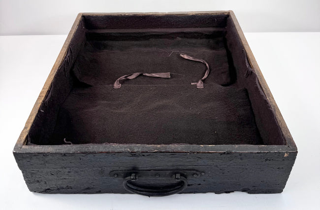 Open shallow drawer from Edo period ship chest showing plain textile lining, ring pull and aged wooden drawer construction