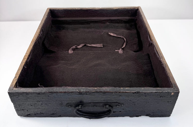 Open shallow drawer from Edo period ship chest showing plain textile lining, ring pull and aged wooden drawer construction