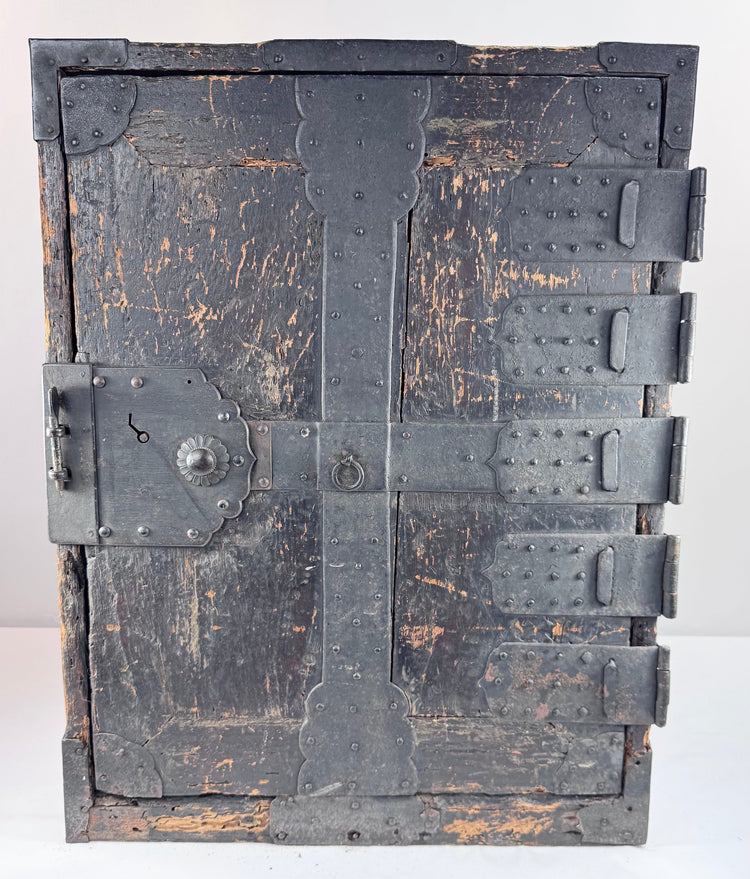 Front view of Japanese funa tansu showing reinforced exterior door, five iron hinge straps and chrysanthemum-form lock ornament