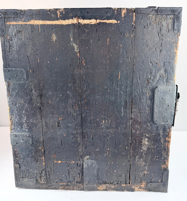 Side view of antique funa tansu displaying iron reinforcement bands, aged wood surface and maritime chest construction