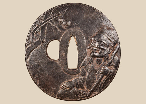 Antique Japanese iron tsuba with mixed-metal sage and spider design displayed beside its Japanese purchase receipt