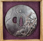 Edo–Meiji Japanese tsuba displayed inside a fitted wooden box with deep purple textile lining