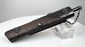 Antique Japanese Meiji period kayaku-ire gunpowder flask showing textured reddish-brown body, floral metal appliqués, beaded bosses, dispensing spout and securing chain