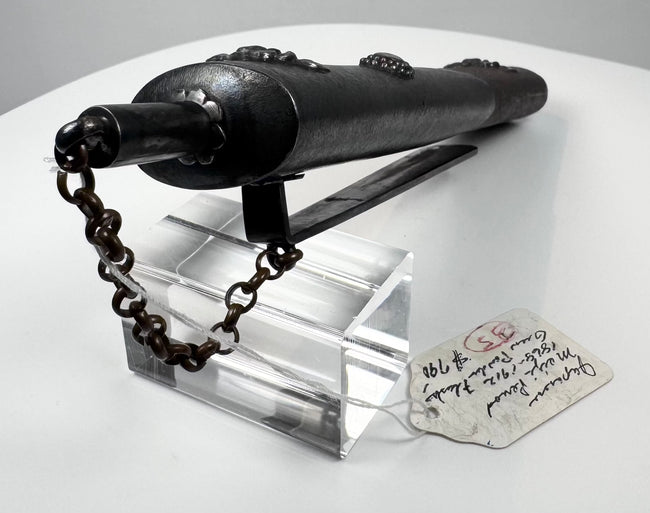 Side view of antique Japanese kayaku-ire showing powder spout, securing chain and reverse suspension hardware