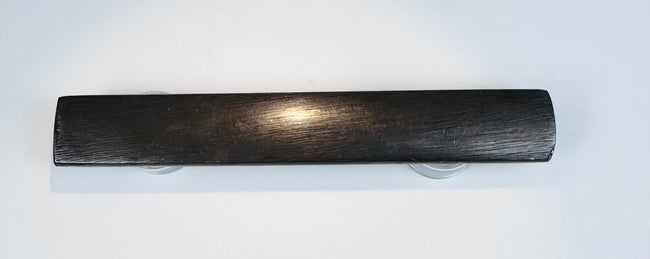 Reverse of the patinated Japanese kozuka handle with a plain darkened surface