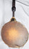 Antique Himalayan ritual percussion instrument with carved anthropomorphic finial and rawhide lacing.