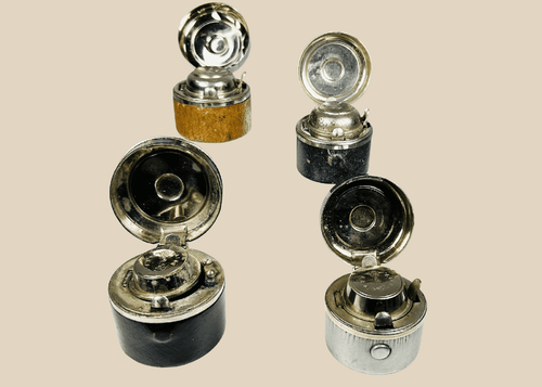 Antique portable inkwells set with leather-wrapped bodies and glass inserts