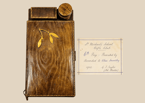 Antique leather writing slope with gilt detailing and inkwell compartment