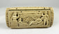 Alternate front panel of a Napoleonic POW carved bone snuff box with relief figures and textured landscape carving on a white background.