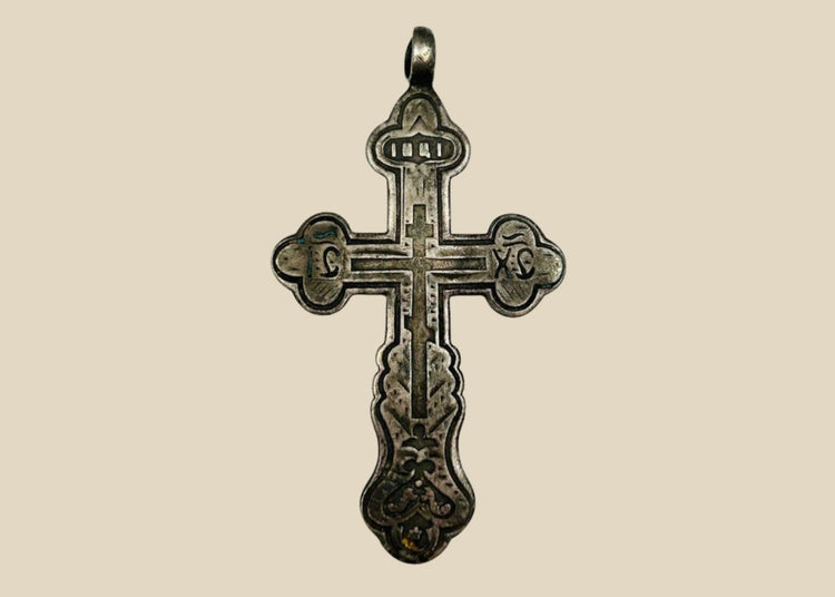 Antique Russian Orthodox silver cross pendant, 18th Century CE. Classic cruciform shape with additional upper crossbar and engraved Cyrillic inscriptions, including “IC XC” for Jesus Christ. Compact wearable devotional pendant with natural silver patina, reflecting Eastern Orthodox artistry, faith, and spiritual symbolism.