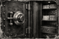 Display mounted antique safe lock showcasing early mechanical engineering