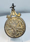 Antique silver Catholic pendant with detailed religious imagery and original decorative suspension fitting.