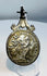 Reverse of a Catholic devotional medal displaying the IHS Christogram and symbols of Christ's Passion.