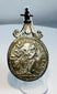 Reverse of a Catholic devotional medal displaying the IHS Christogram and symbols of Christ's Passion.