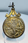 Antique cast silver pendant medal with ornate suspension loop and Christian iconography.