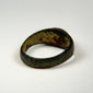 Side angle of Sassanian silver and carnelian ring showing the raised gemstone setting and aged band