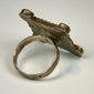 Antique hand-forged silver ring with engraved rectangular bezel and traditional protective decorative motifs