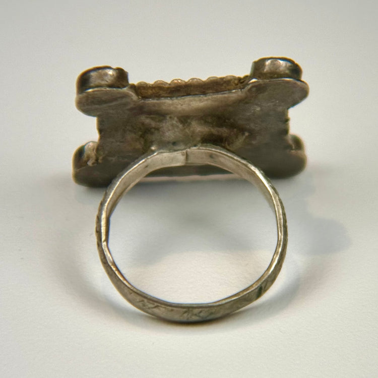 North African silver ring displaying geometric motifs, substantial band construction, and rich aged patina