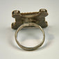 North African silver ring displaying geometric motifs, substantial band construction, and rich aged patina