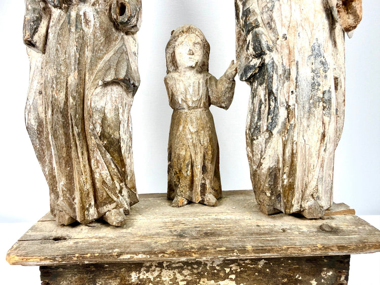 Lower section of Holy Family group showing carved robe drapery folds and child's feet