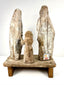 Rear view of antique wooden saints displaying National Museum Philippines sticker and grain