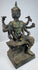Opposite side view of the Thai devotional statue with raised ritual objects