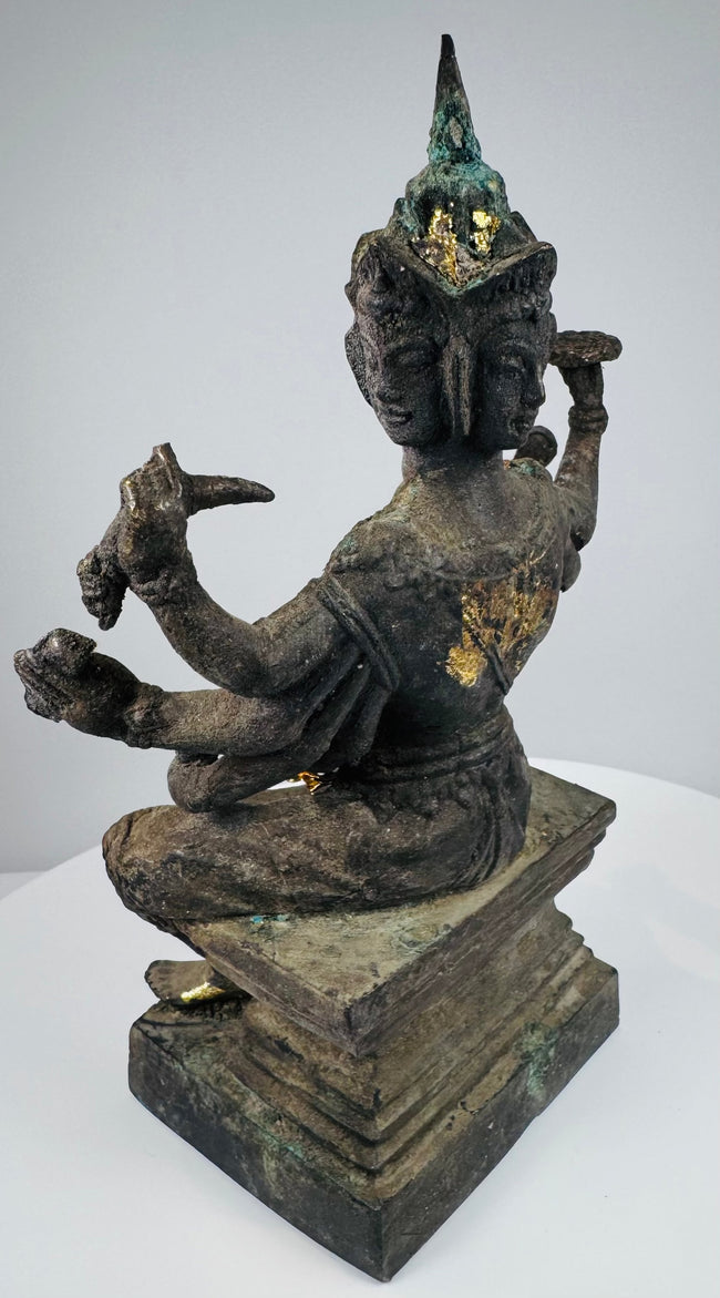 Side view of the eight-armed Thai Brahma statue with verdigris patina
