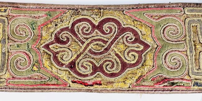 Close-up of Tibetan embroidered belt with colourful scroll and key-pattern decoration