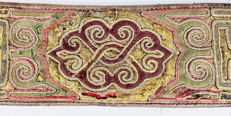 Close-up of Tibetan embroidered belt with colourful scroll and key-pattern decoration
