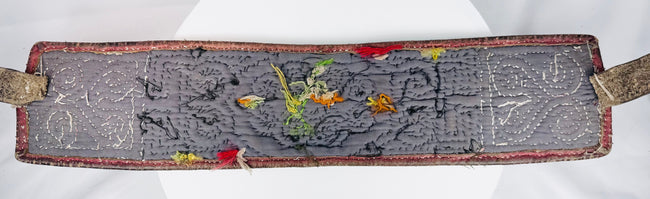Back view of Tibetan warrior belt showing hand stitching, straps, wear, and old repairs