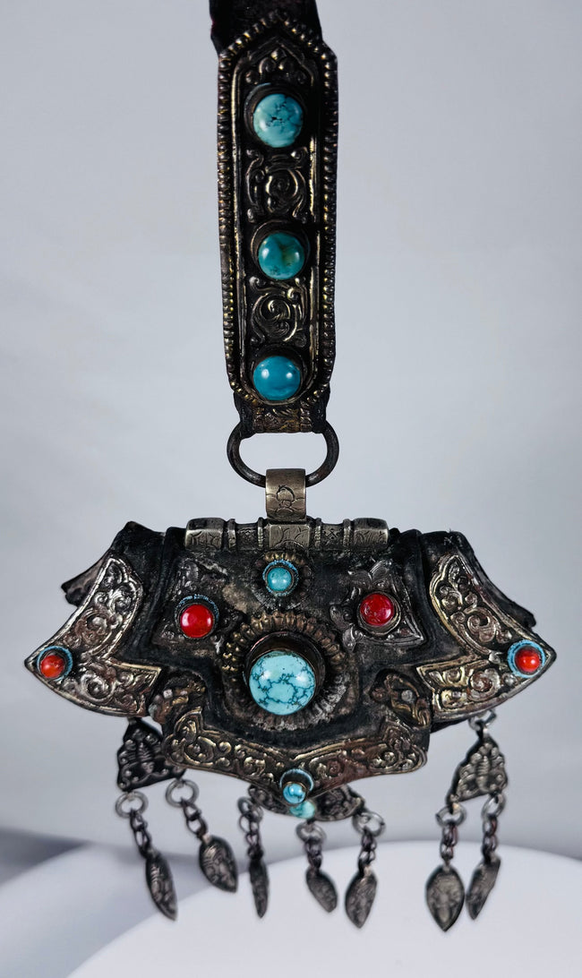 Large Tibetan gau shrine pendant with suspended leaf-shaped drops and decorative turquoise stone settings.
