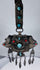 Late 19th century Tibetan ceremonial chest ornament with silvered metal, turquoise, coral, and hanging pendants.