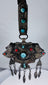 Late 19th century Tibetan ceremonial chest ornament with silvered metal, turquoise, coral, and hanging pendants.