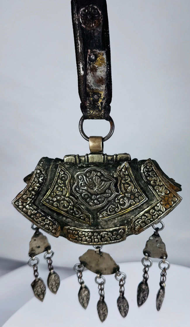 Authentic Himalayan ceremonial ornament featuring turquoise, coral, silvered copper alloy, and ornate repoussé craftsmanship.