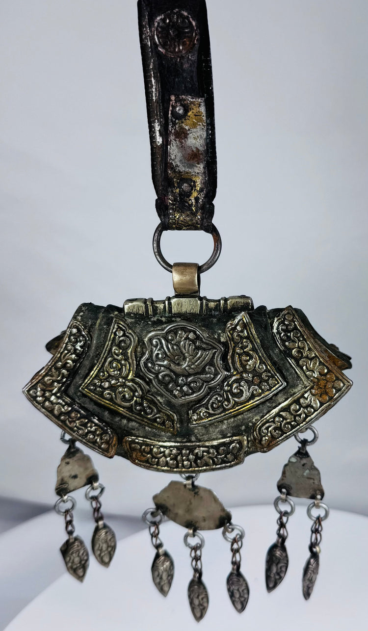 Authentic Himalayan ceremonial ornament featuring turquoise, coral, silvered copper alloy, and ornate repoussé craftsmanship.