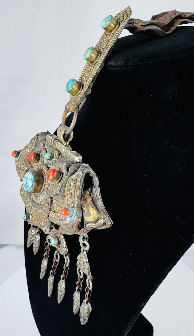 Museum-quality Tibetan gau pendant from the Himalayan region with decorative repoussé details and sacred amulet compartment.