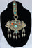 Traditional Himalayan gau amulet case featuring repoussé metalwork, turquoise inlay, and suspended pendant drops.